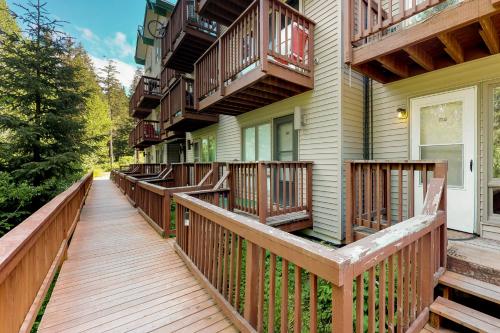 a wooden walkway leading to a house with balconies at North 413 in Girdwood