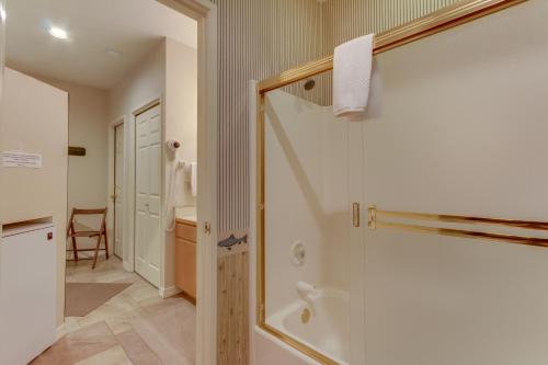 a bathroom with a shower with a glass door at Seclusion in Century West in Bend