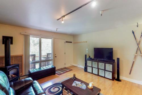 a living room with a couch and a tv at North 413 in Girdwood