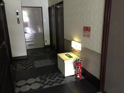 a room with a fire hydrant in a hotel room at Business Stay in Satsumasendai