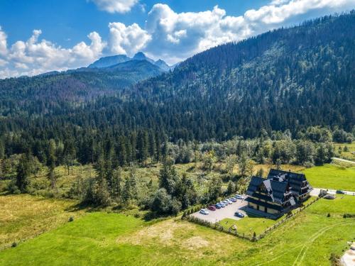 an aerial view of a house in the mountains at Hotel Eco Tatry Holiday& Spa in Kościelisko