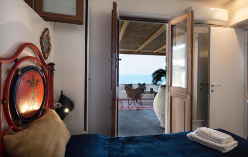 a bedroom with a bed and a view of the ocean at Casa 34 Dicembre in Stromboli