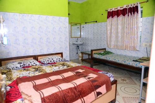 a bedroom with two beds and a sink at Sri Ranga Homestay in Māvingundi