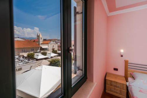 a bedroom with a window with a view at Apartment Keti in Novalja