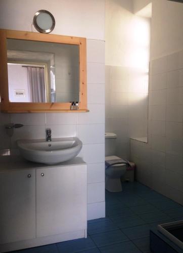 a bathroom with a sink and a toilet at Piazza Castello in Plaka Milou