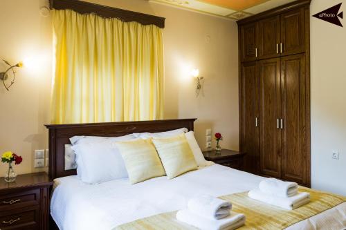a bedroom with a large bed with towels on it at Villa Paroraia in Tsepelovo