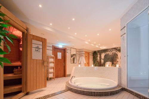 a large bathroom with a tub in the middle at ACHAT Hotel Lohr am Main in Lohr