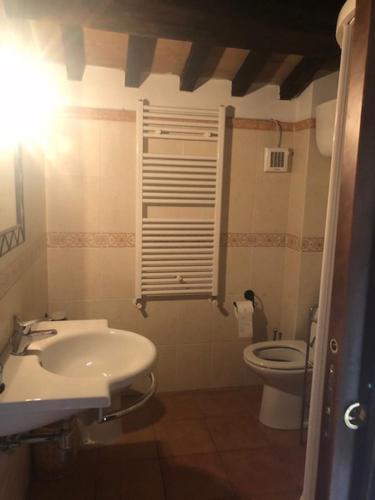 a bathroom with a sink and a toilet at Appartamento Bella Vista in Assisi