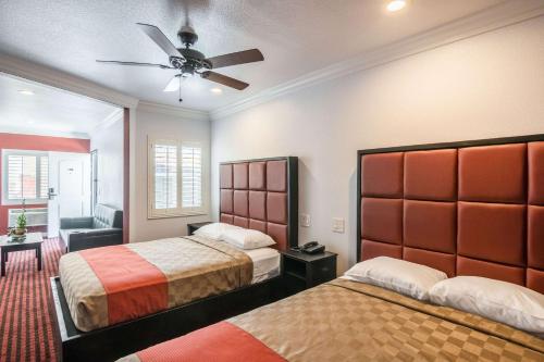 a bedroom with two beds and a ceiling fan at El Dorado Inn in Lynwood