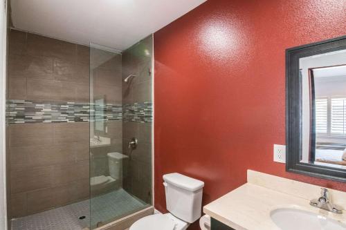 a bathroom with a shower and a toilet and a sink at El Dorado Inn in Lynwood