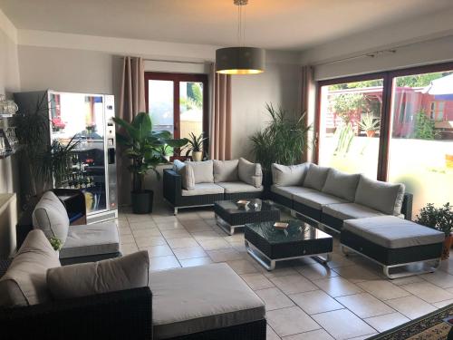 a large living room with couches and tables at City-Hotel-Wolgast in Wolgast