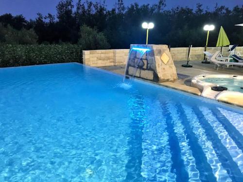 a swimming pool with a water slide in the middle at Green Park Hotel & Residence in Bagnara Calabra