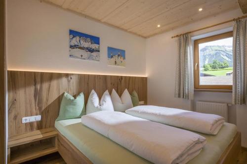 a bedroom with two beds and a window at Appartement Hinterholzer in Going