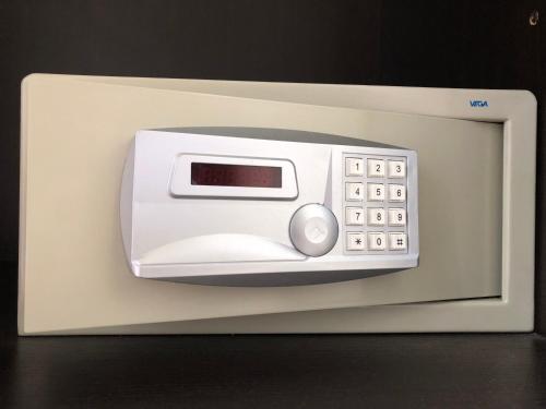 a white microwave oven with a digital clock on it at Hotel Brenta Milano in Milan