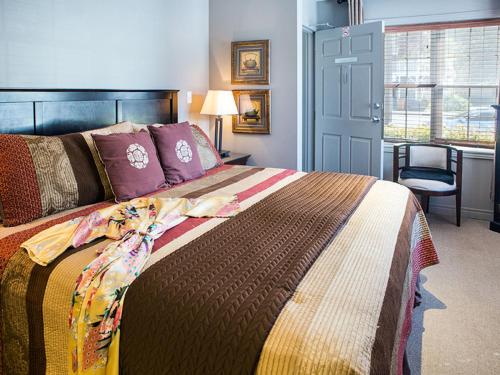a bedroom with a large bed and a window at Inn on the Harbour and Telegraph House in Port Stanley