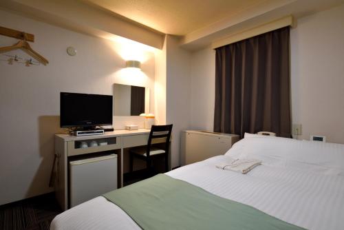 Postel nebo postele na pokoji v ubytování Hotel Johzenji