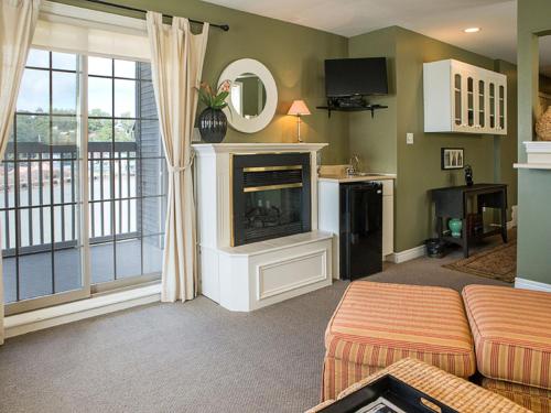 a living room with a couch and a fireplace at Inn on the Harbour and Telegraph House in Port Stanley