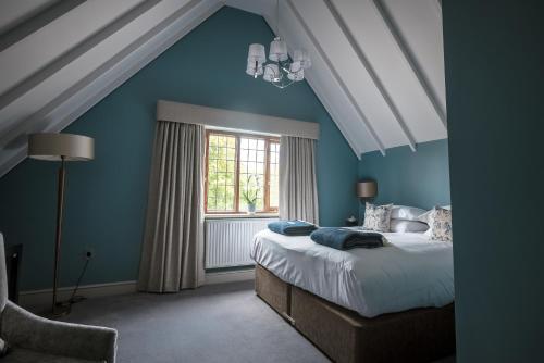 En eller flere senge i et værelse på Hogarths Stone Manor