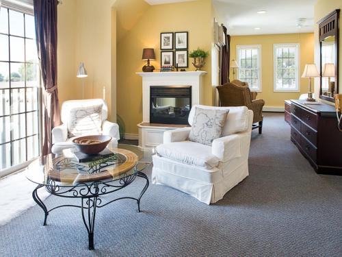 a living room with two chairs and a coffee table at Inn on the Harbour and Telegraph House in Port Stanley