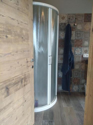 a bathroom with a stainless steel refrigerator in a room at Su Misura in Molini