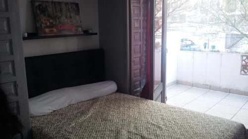 a bedroom with a bed and a large window at 15 C/MUGA-A EMPURIABRAVA in Empuriabrava