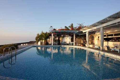 a large swimming pool in front of a building at Sigalas Beach Hotel in Kamari