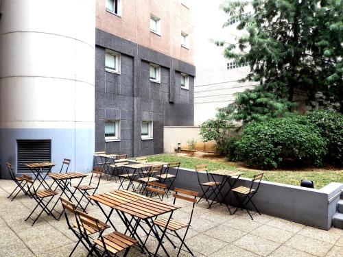 a group of tables and chairs in front of a building at ibis budget Paris Porte d'Italie Est in Le Kremlin-Bicêtre