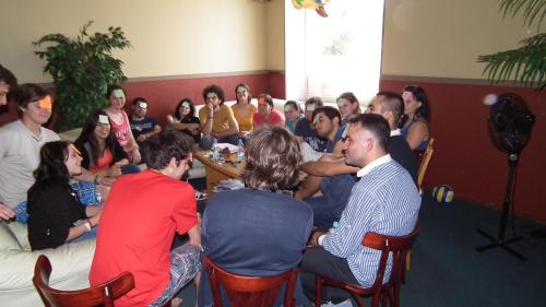 a group of people sitting around a table in a room at Hotel Erfolg in Daugavpils