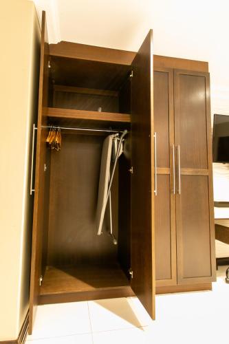 a cupboard with a door open in a room at Royl Court Guesthouse in Kimberley
