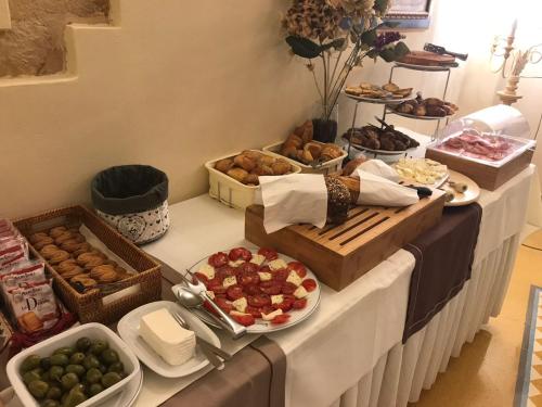 a table topped with lots of different types of food at Domus Mariae Benessere in Siracusa