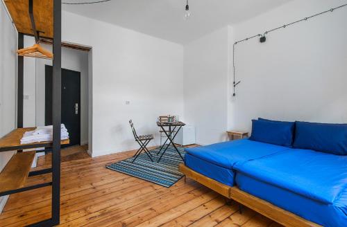 a living room with a blue bed and a ladder at Generaator Sofia in Sofia