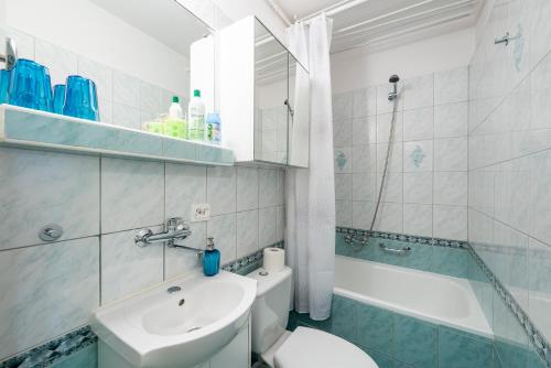 a bathroom with a sink and a toilet and a tub at Stare Miasto - Trębacka in Warsaw