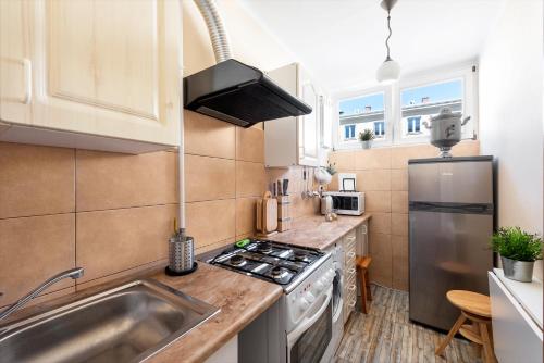 a kitchen with a sink and a stove top oven at Stare Miasto - Trębacka in Warsaw