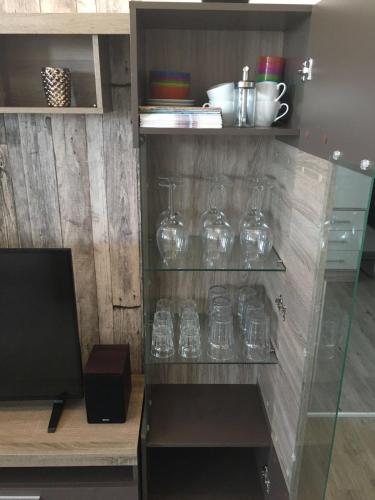 a bunch of glasses on a shelf in a room at Muschelnische Strandhaferweg in Fehmarn