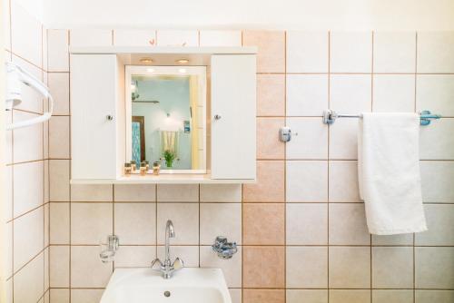 a bathroom with a sink and a mirror at Hotel Sofia in Matala