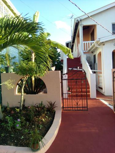 a stairway leading to a house with a gate at LeMarida Suites in Saint Peter