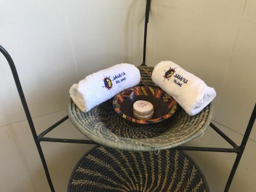 a table with towels on top of a chair at Samuka Island Retreat in Jinja