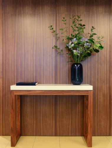 a table with a vase of flowers on it at Hotel Navarras in Amarante