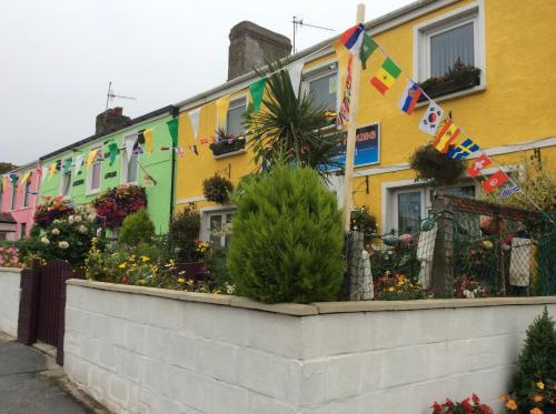 a row of colorful houses with flags on them at Globe Guesthouse in Burry Port