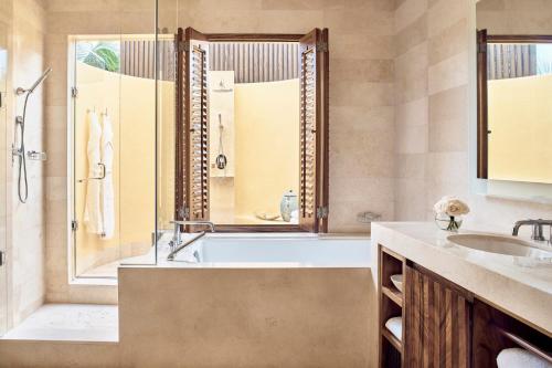 a bathroom with a tub and a sink at Four Seasons Resort Punta Mita in Punta Mita