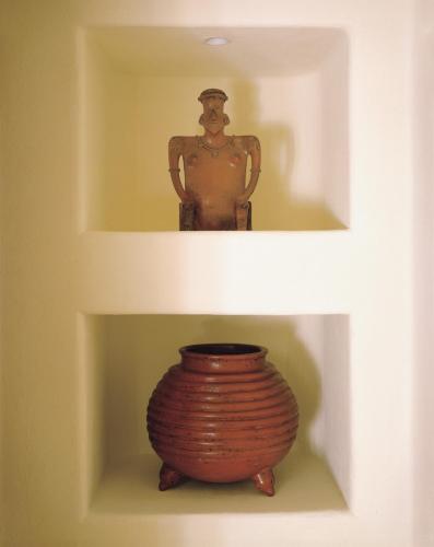 a statue of a man on a shelf with a vase at Four Seasons Resort Punta Mita in Punta Mita