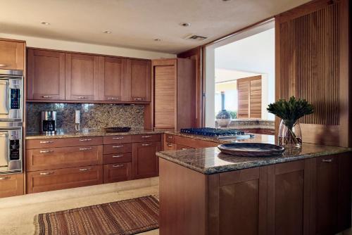 a large kitchen with wooden cabinets and a large window at Four Seasons Resort Punta Mita in Punta Mita