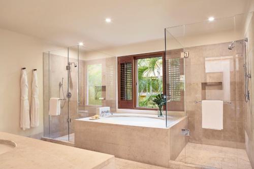 a bathroom with a tub and a glass shower at Four Seasons Resort Punta Mita in Punta Mita