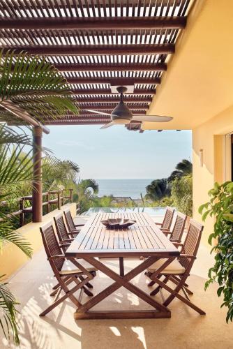 a wooden table and chairs on a patio at Four Seasons Resort Punta Mita in Punta Mita