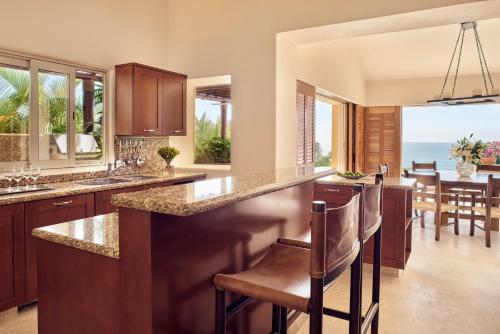 a kitchen with a large island with a view of the ocean at Four Seasons Resort Punta Mita in Punta Mita
