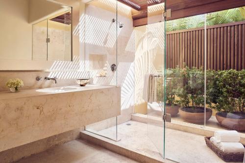 a bathroom with a sink and a glass shower at Four Seasons Resort Punta Mita in Punta Mita