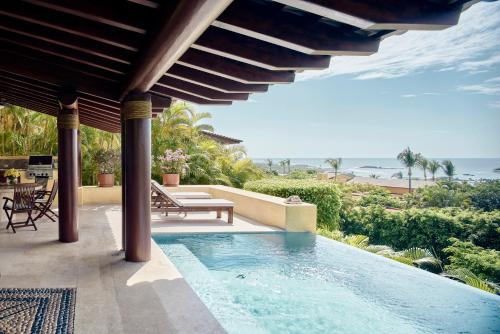 a swimming pool in a house with a view of the ocean at Four Seasons Resort Punta Mita in Punta Mita