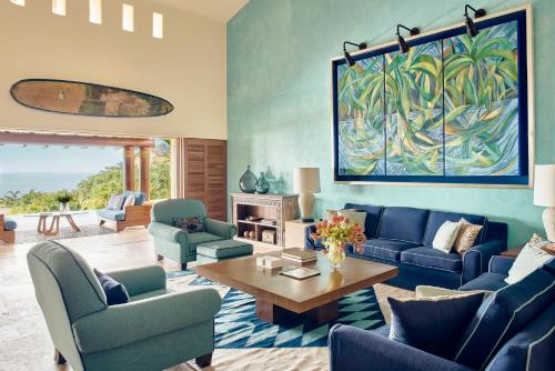 a living room with blue couches and a table at Four Seasons Resort Punta Mita in Punta Mita