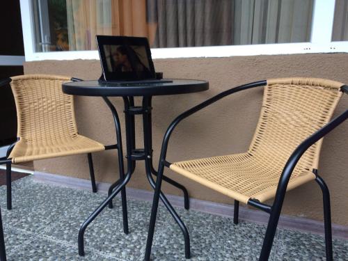 a table and two chairs with a laptop on it at Comfortable Apartment near the Sea in K'obulet'i