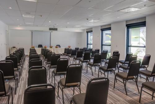 a room with chairs and a table in it at Linx Galeão by Wish in Rio de Janeiro